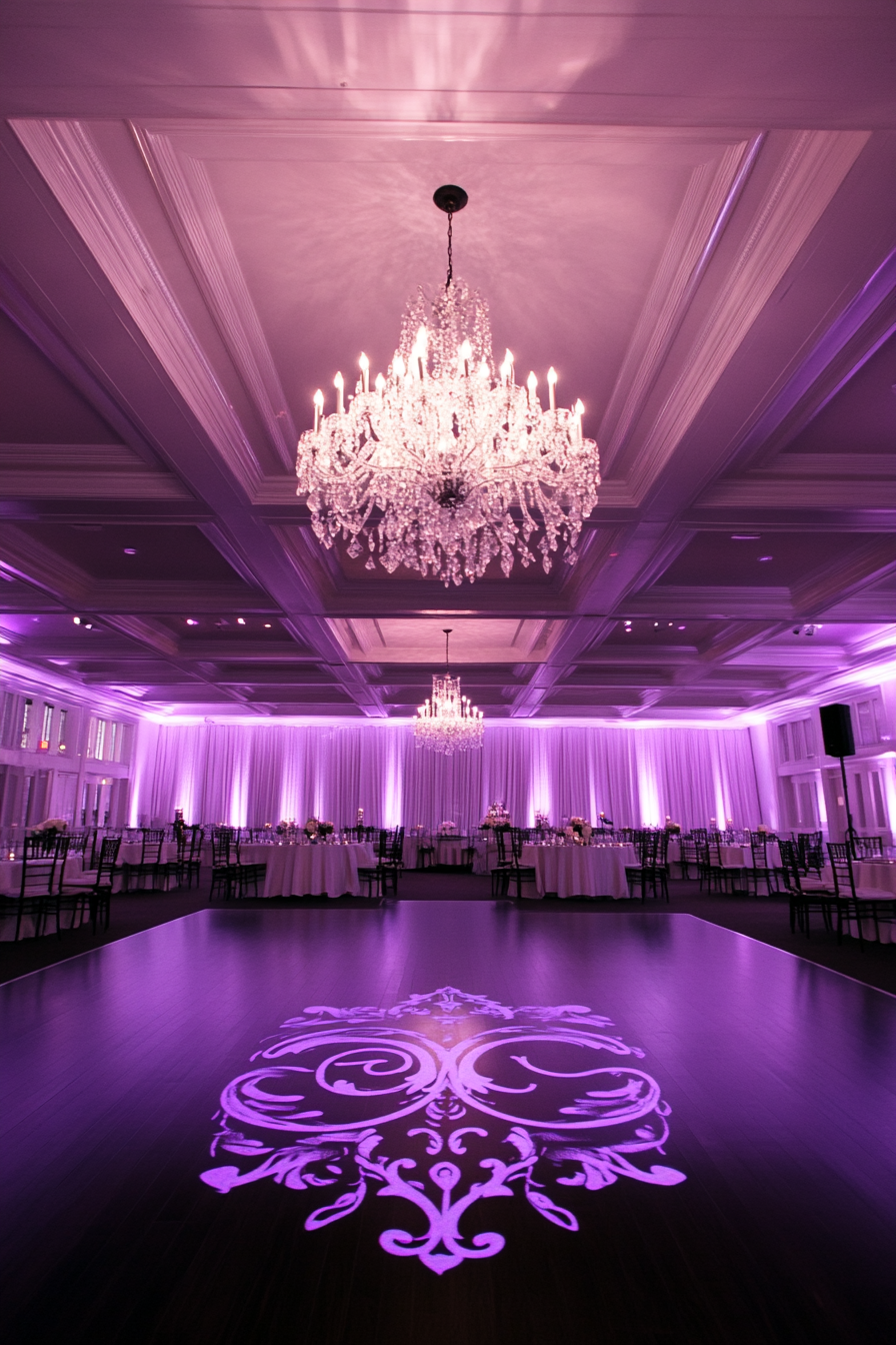 Wedding Entertainment Space. Crystal chandelier, ebony floor, monogram projection, LED purple borders.