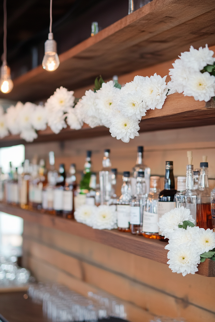 Wedding bar display. Hanging shelves, white chrysanthemum garlands.