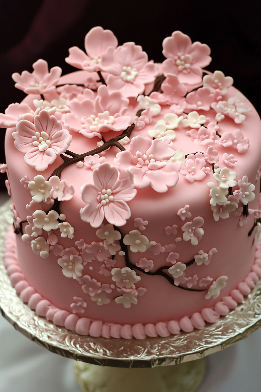 Wedding cake. Pastel pink icing with fondant floral detailing.