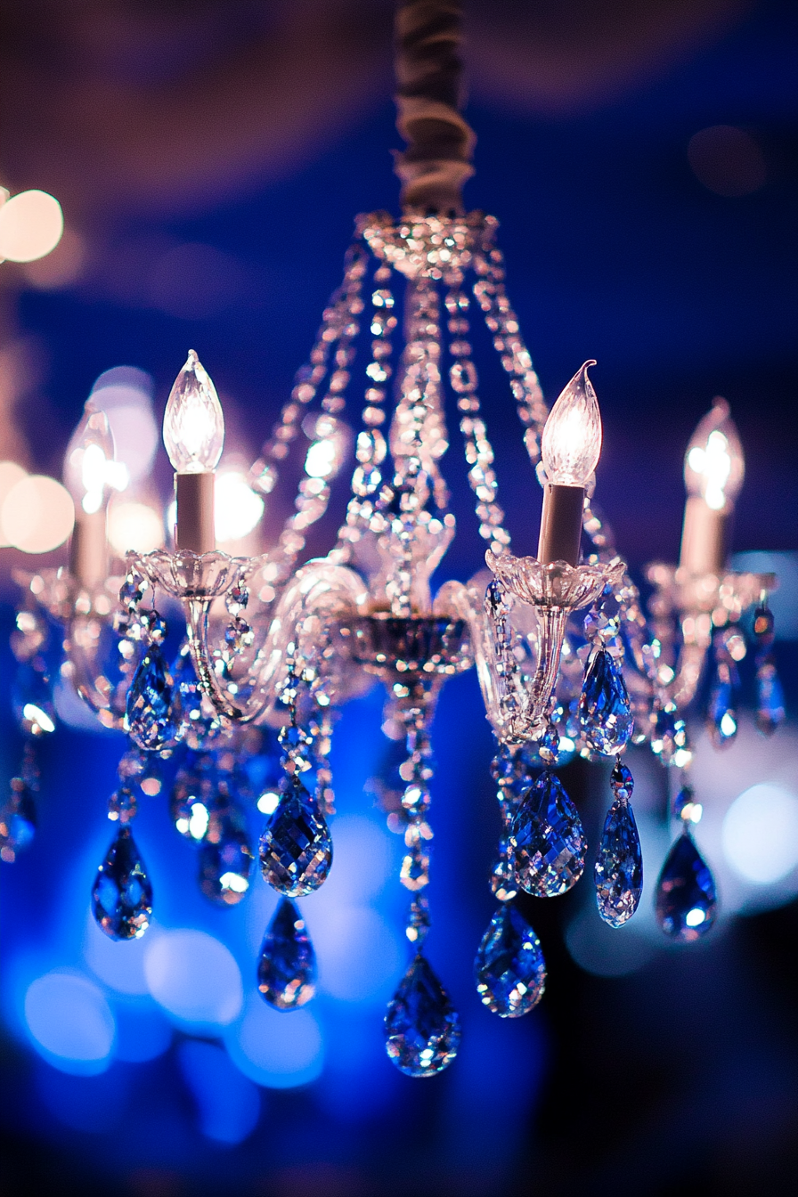 Wedding reception lighting. Chandelier adorned with crystal beads and cobalt blue accents.