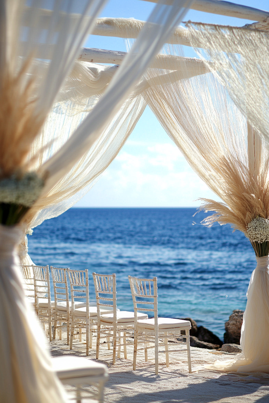 Wedding style. Pearl-white drapes, seagrass textures, and shell-inspired colors against blue ocean backdrop.